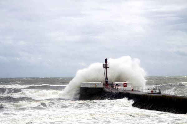 30th April 2012 - Storm waves crash over the iconic Banjo Pier at Looe.